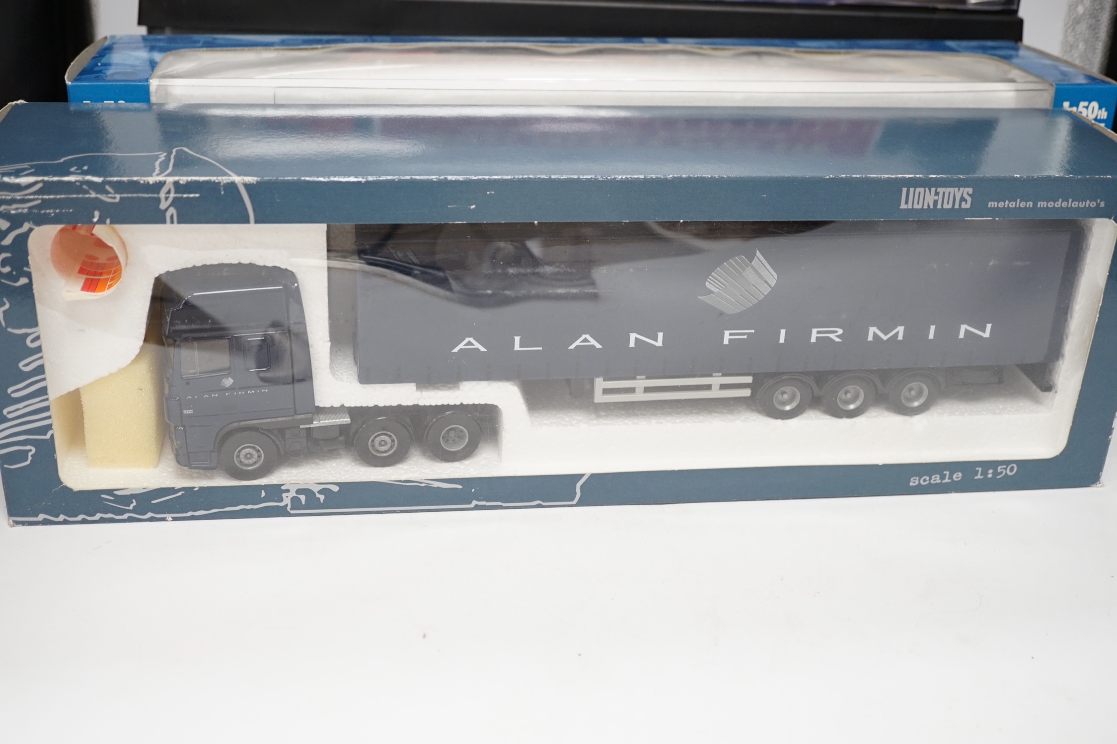 Four boxed Corgi and Universal Hobbies 1:50 scale articulated trucks; a Leyland DAF lorry (75401), an ERF curtainside lorry (75203), a Lion Toys DAF with box trailer, and a Universal Hobbies Scania Topline